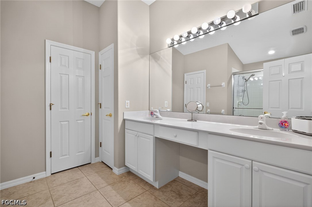 10082 Oakhurst Way Fort Myers, FL 33913 - Photo 19 of 50 a bathroom with a double vanity sink and a mirror