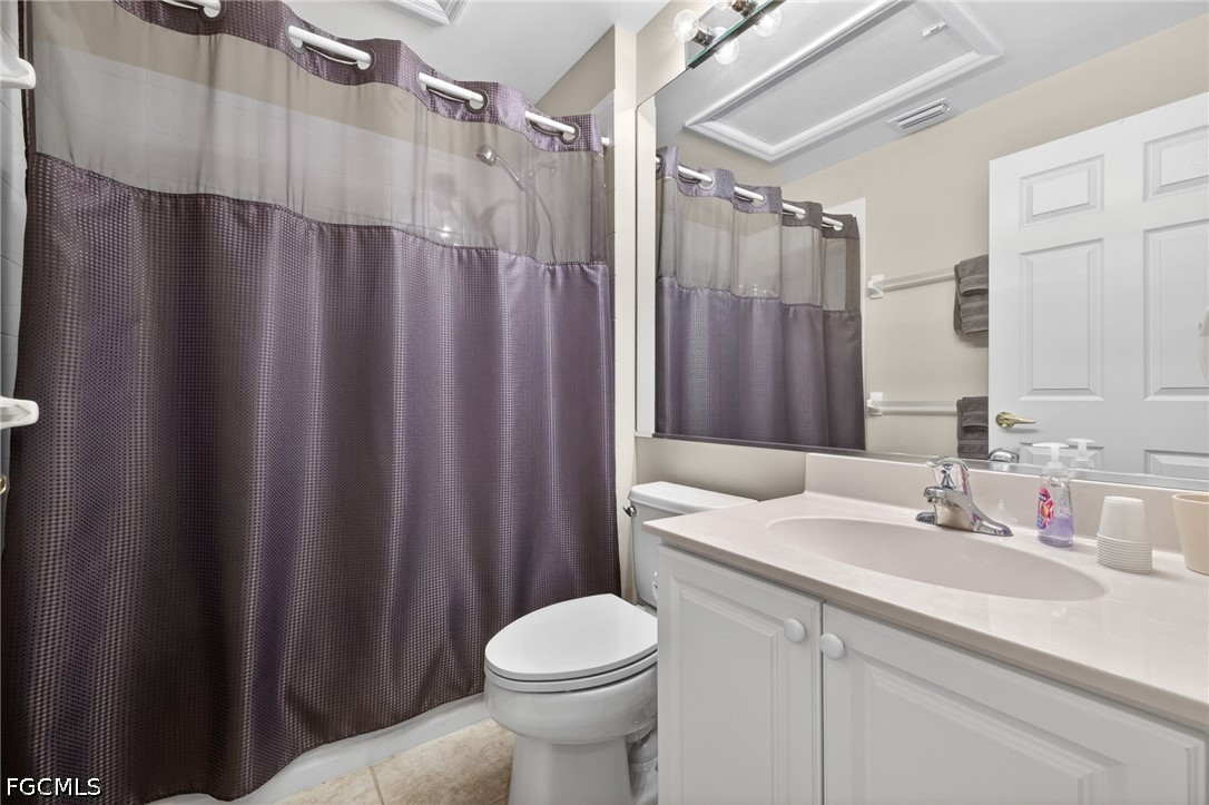 10082 Oakhurst Way Fort Myers, FL 33913 - Photo 22 of 50 a bathroom with a sink a toilet a mirror and shower curtain