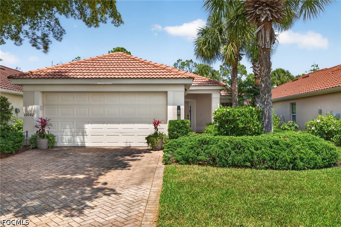 10082 Oakhurst Way Fort Myers, FL 33913 - Photo 50 of 50 a front view of a house with a yard and garage