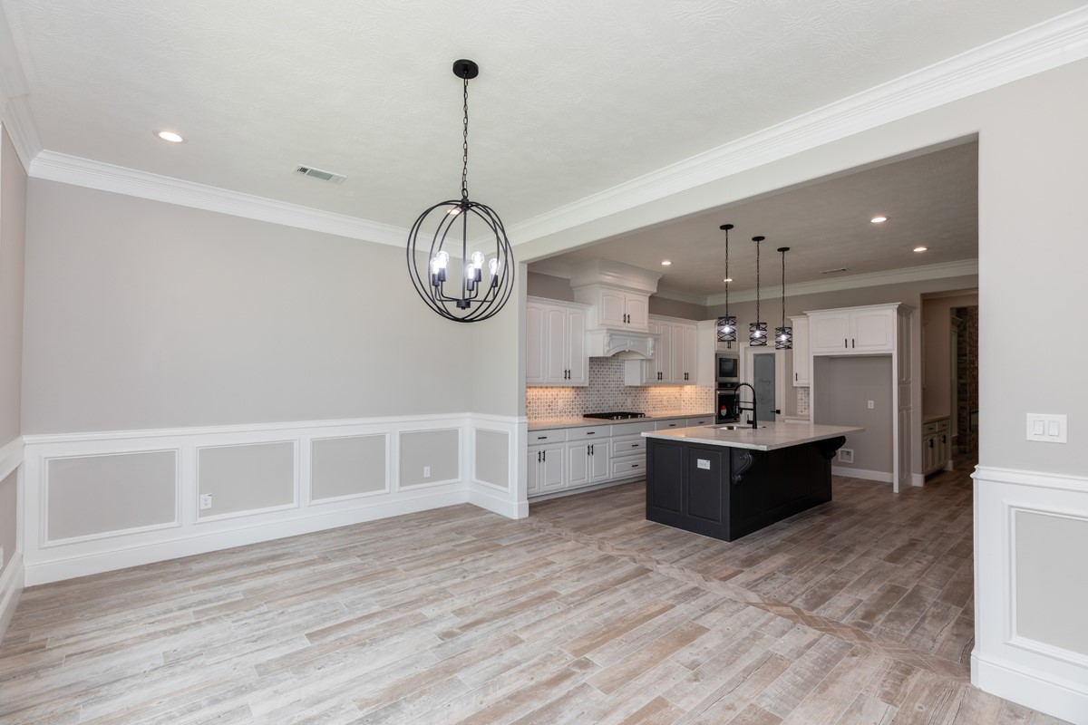 7705 Water Edge Beaumont, TX 77707 - Photo 11 of 39 a large kitchen with a lot of cabinets and wooden floor