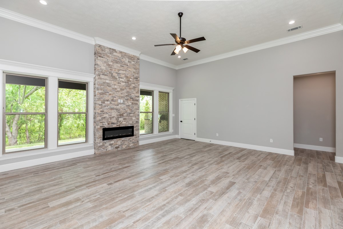 7705 Water Edge Beaumont, TX 77707 - Photo 14 of 39 a view of an empty room with a window and wooden floor