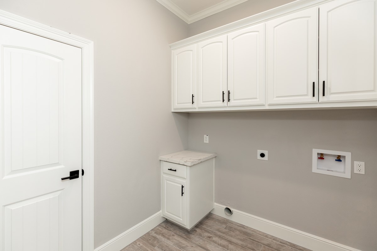 7705 Water Edge Beaumont, TX 77707 - Photo 17 of 39 a view of cabinets and wooden floor