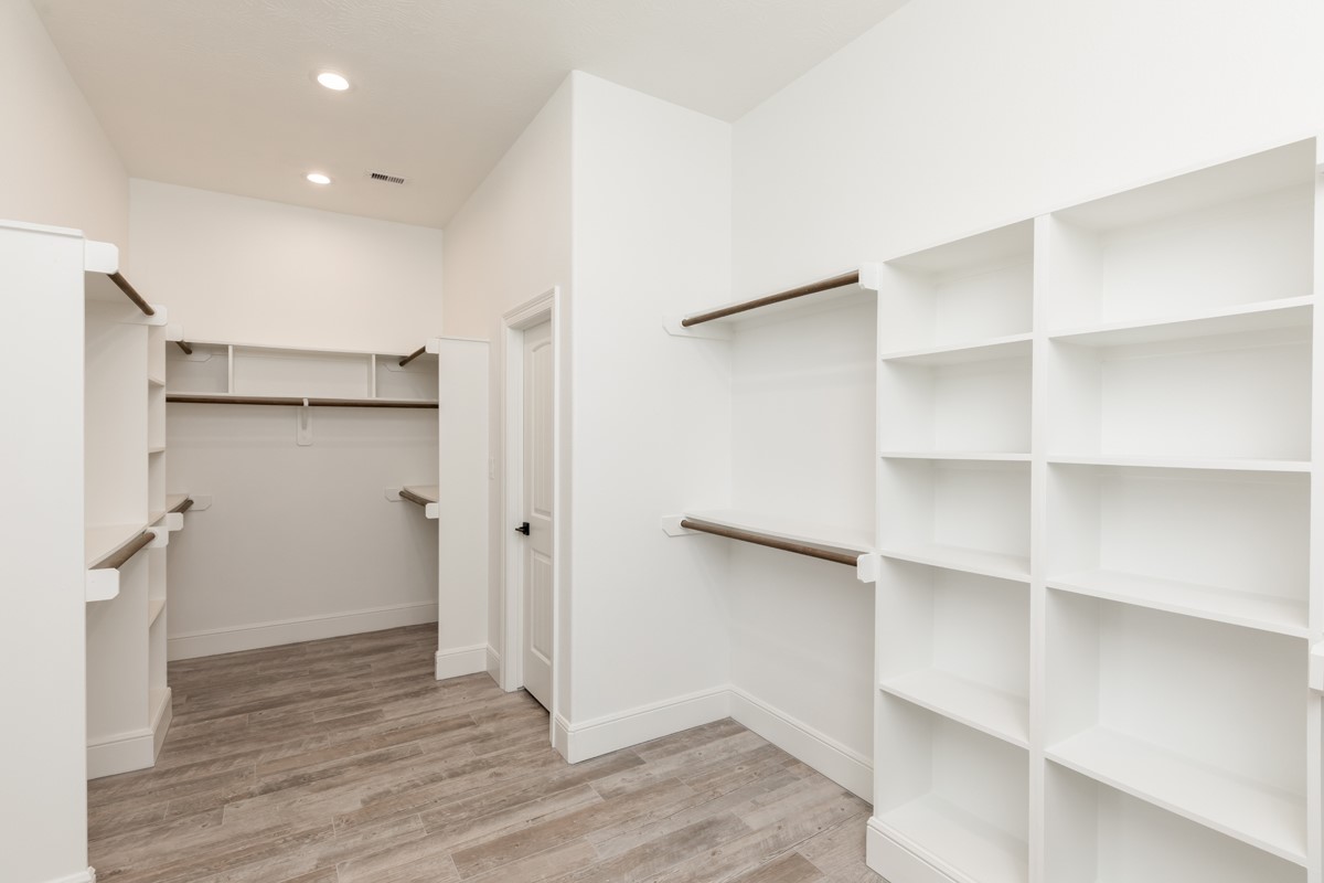 7705 Water Edge Beaumont, TX 77707 - Photo 23 of 39 a view of walk in closet with wooden floor