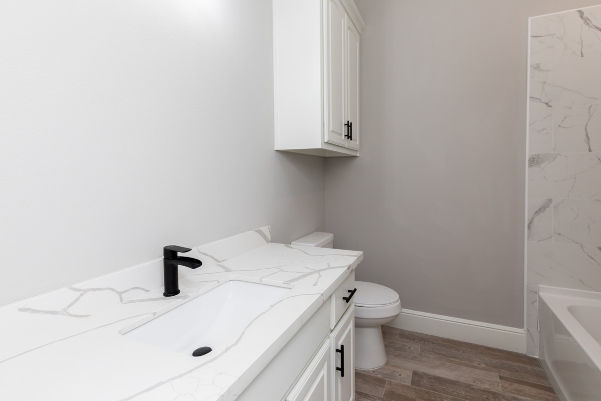 7705 Water Edge Beaumont, TX 77707 - Photo 26 of 39 a bathroom with a sink toilet and vanity