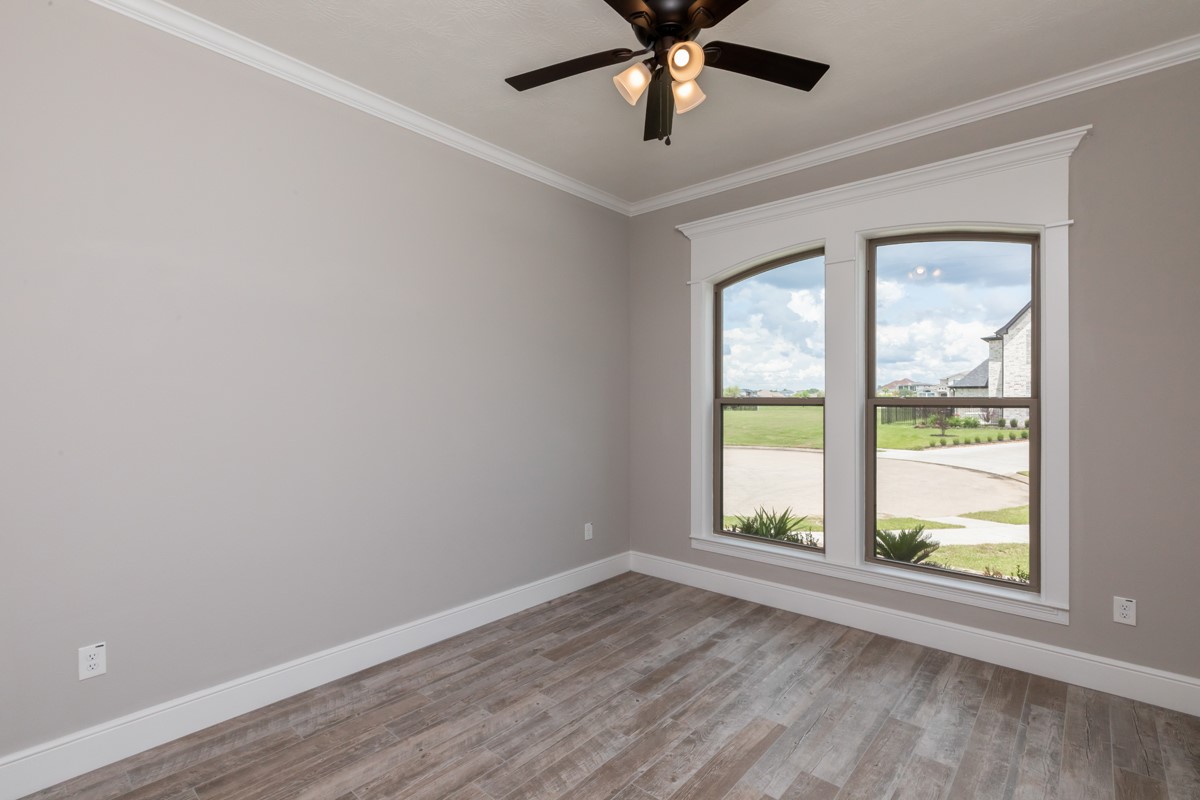 7705 Water Edge Beaumont, TX 77707 - Photo 27 of 39 an empty room with a window and a ceiling fan