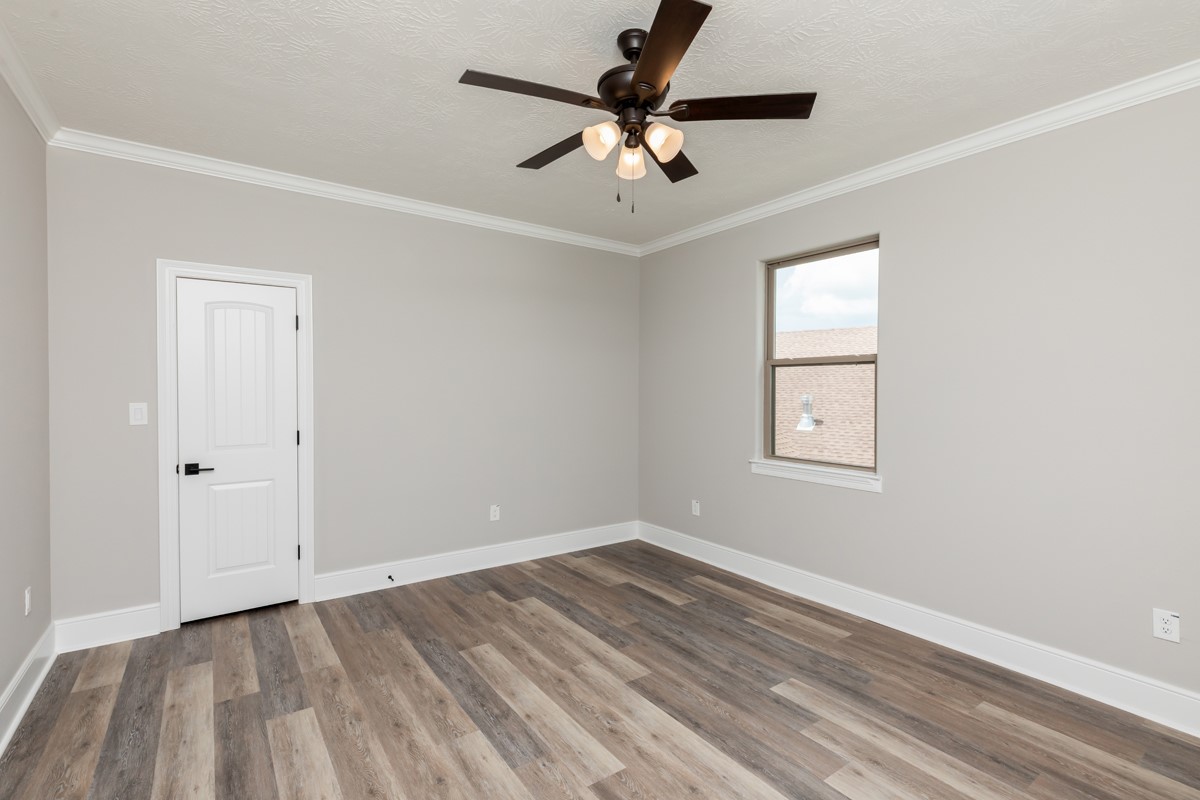 7705 Water Edge Beaumont, TX 77707 - Photo 31 of 39 an empty room with a window and a fan