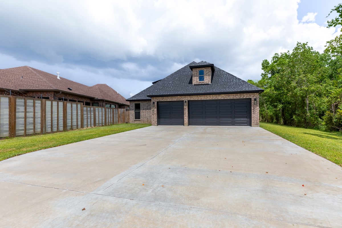 7705 Water Edge Beaumont, TX 77707 - Photo 38 of 39 a front view of a house with a garden and yard