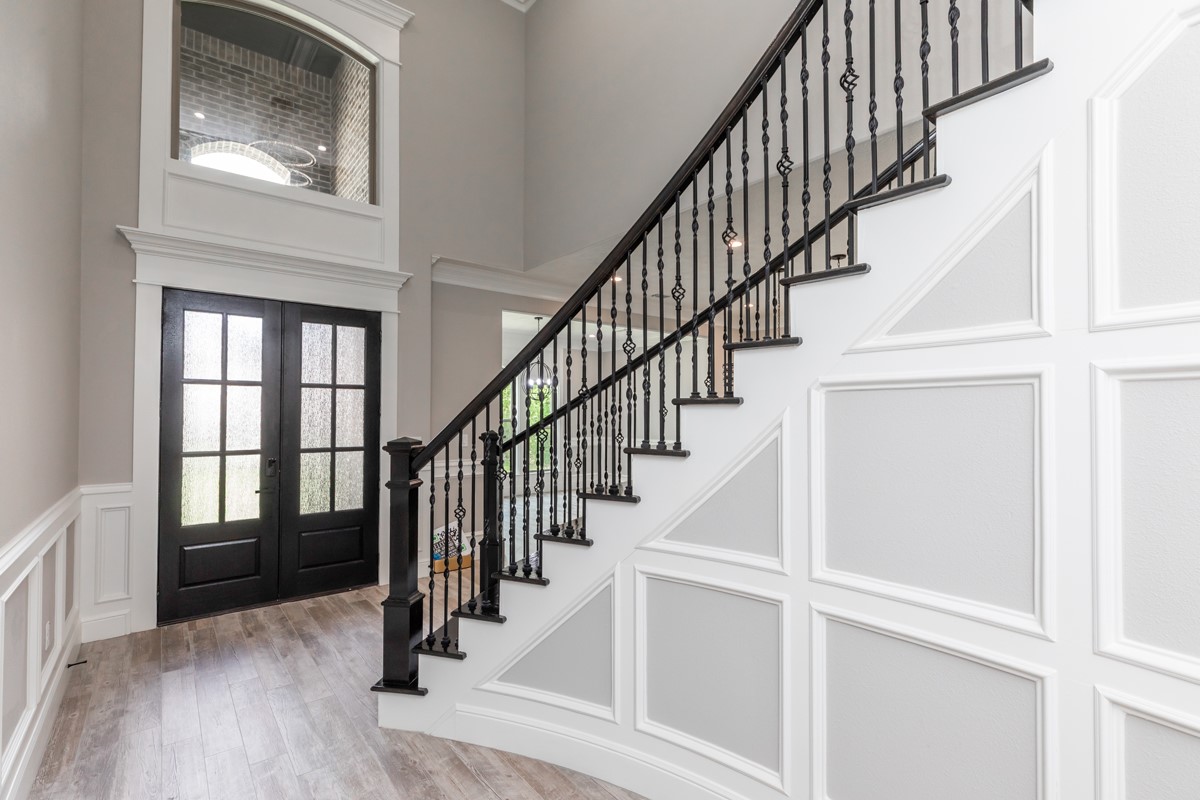 7705 Water Edge Beaumont, TX 77707 - Photo 4 of 39 a view of staircase with wooden floor and a front door