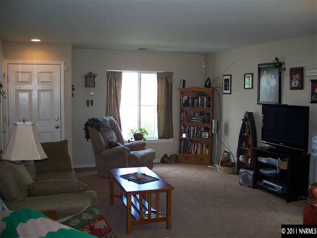 7790 Corso Street Reno, NV 89506 - Photo 3 of 13 a living room with furniture a window and a flat screen tv