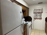 a kitchen with a refrigerator and a stove