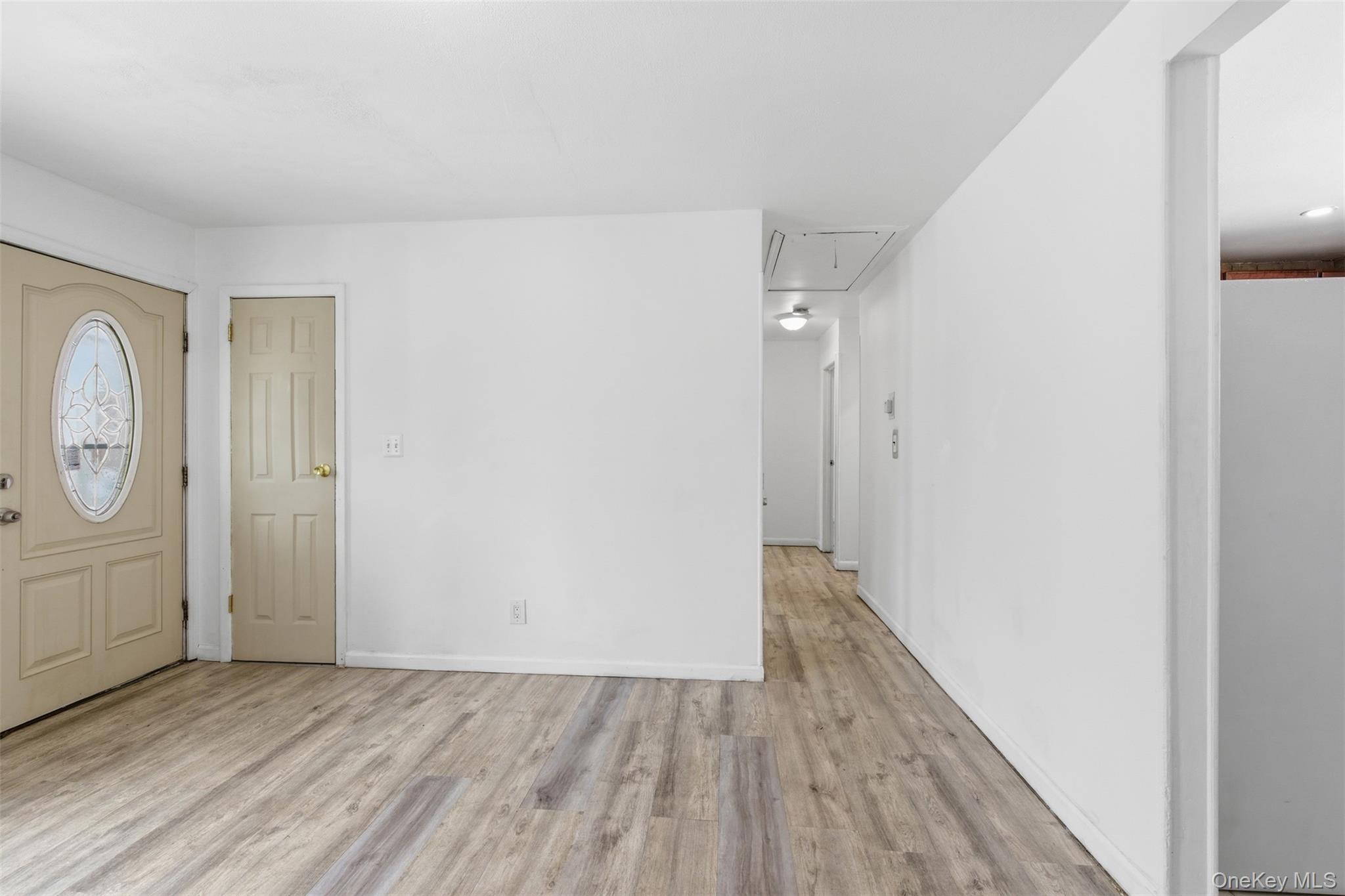 717 Doane Avenue Bellport, NY 11713 - Photo 11 of 22 Foyer with light wood-style floors and baseboards
