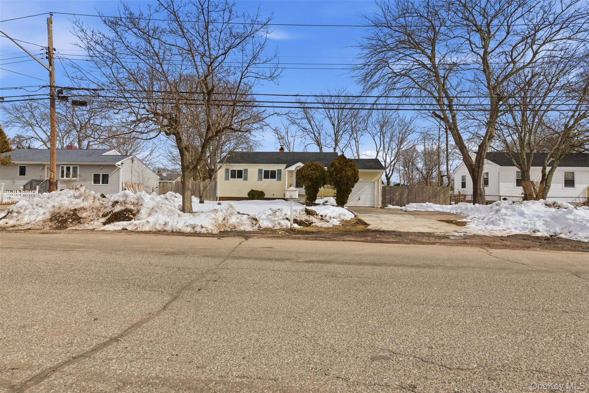 717 Doane Avenue Bellport, NY 11713 - Photo 20 of 22 View of front of home with a chimney and an attached garage