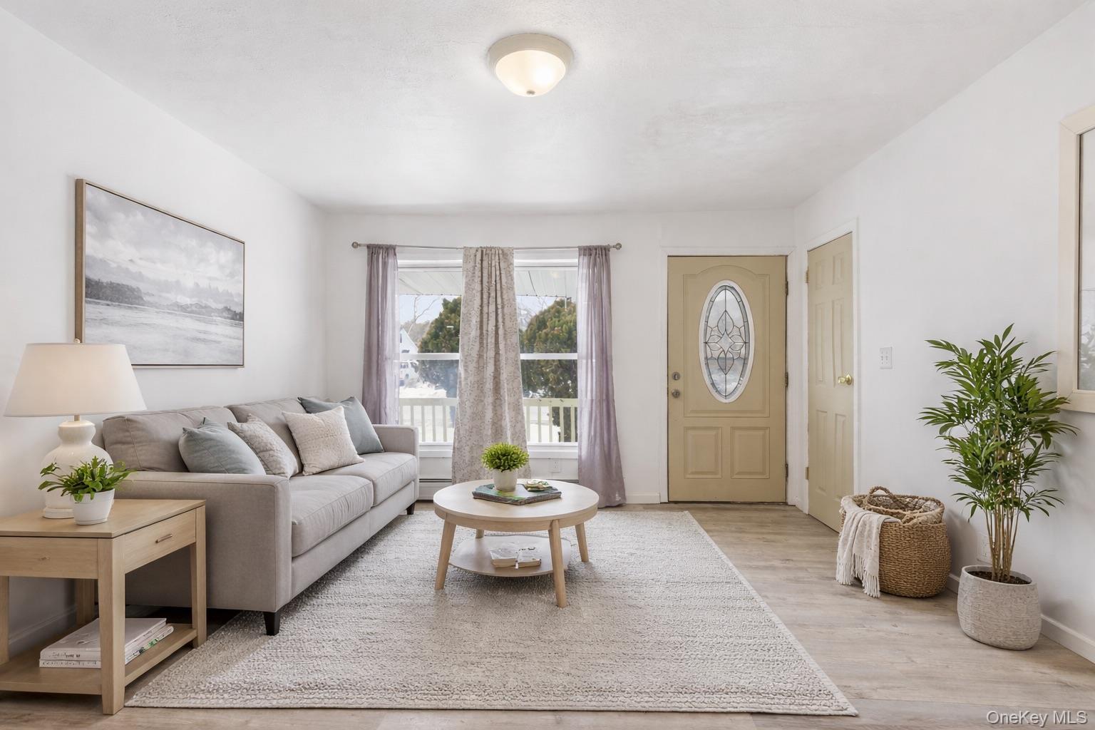 717 Doane Avenue Bellport, NY 11713 - Photo 7 of 22 Living room with light wood-type flooring and baseboards