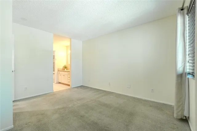a view of an empty room and a window