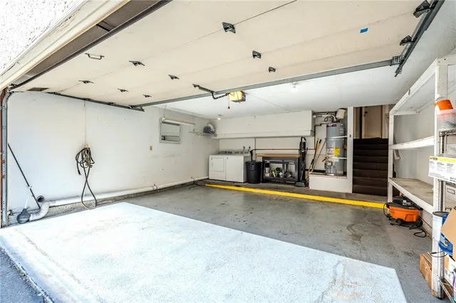 a view of a storage & utility room with two washing machine