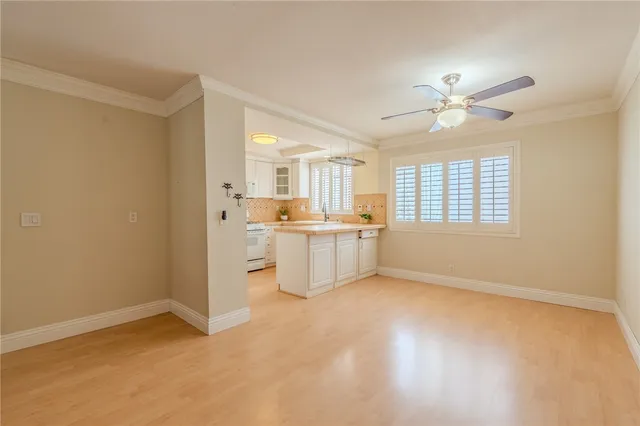 a view of an empty room with a kitchen