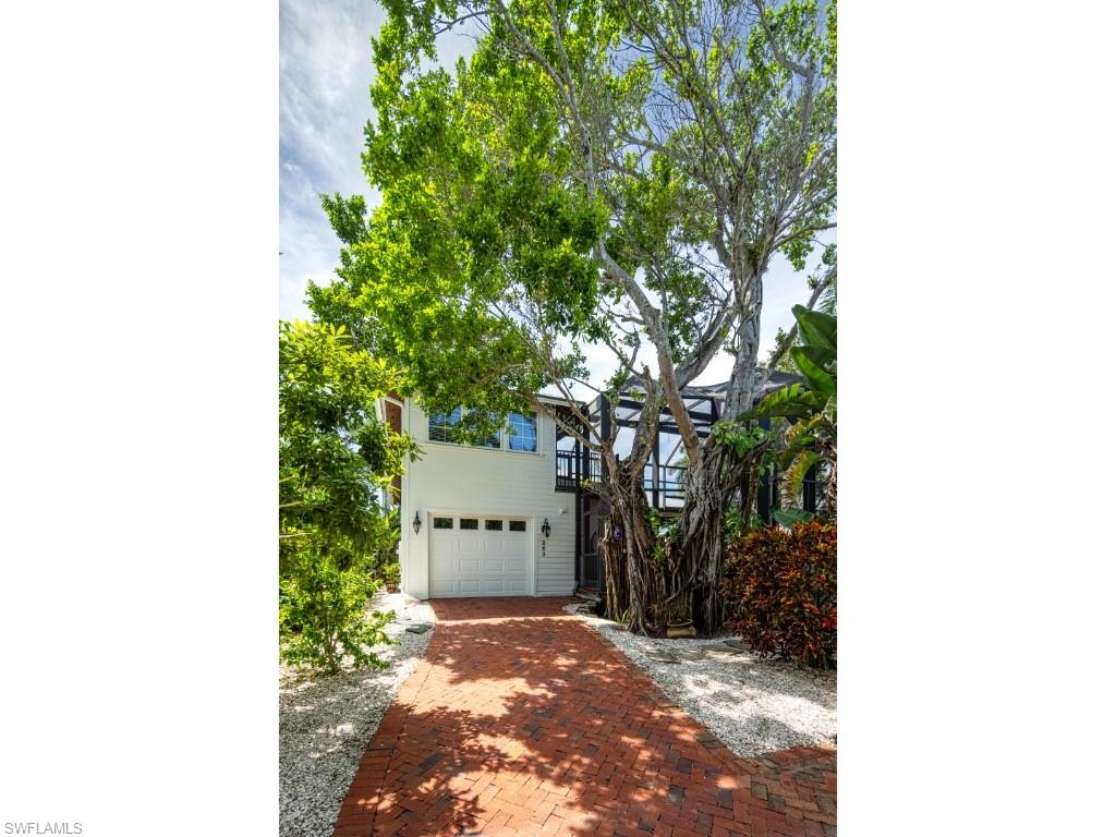 263 10th Avenue South Naples, FL 34102 - Photo 16 of 18 a picture of a tree in front of a house
