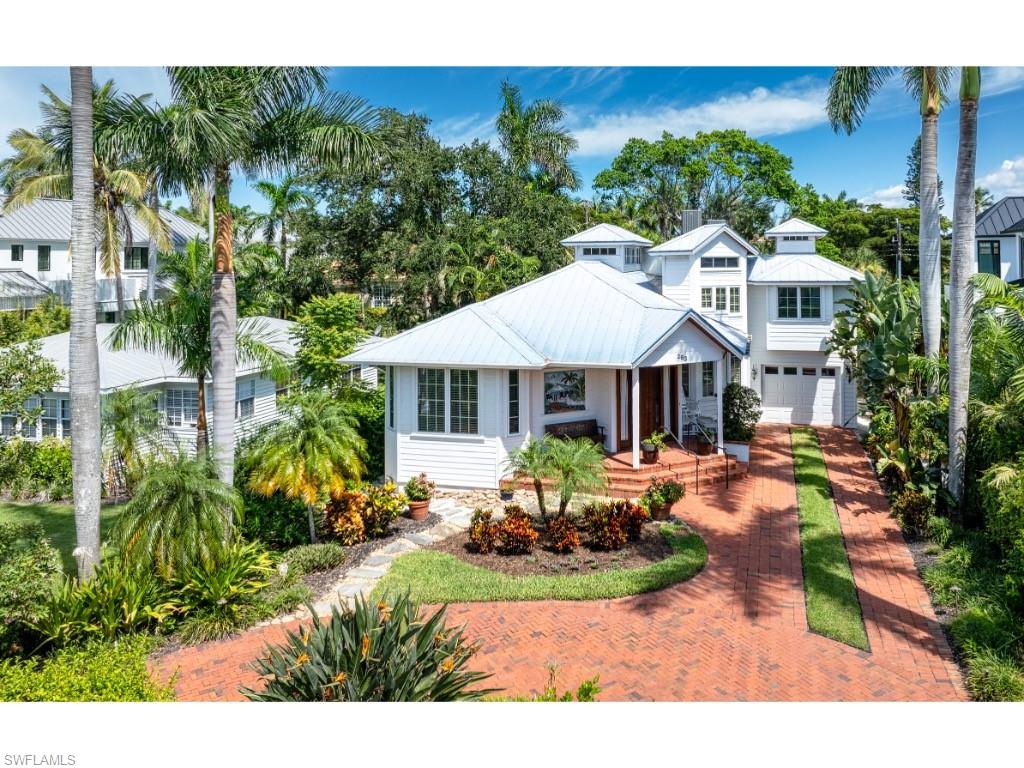 263 10th Avenue South Naples, FL 34102 - Photo 17 of 18 a front view of a house with yard patio and swimming pool