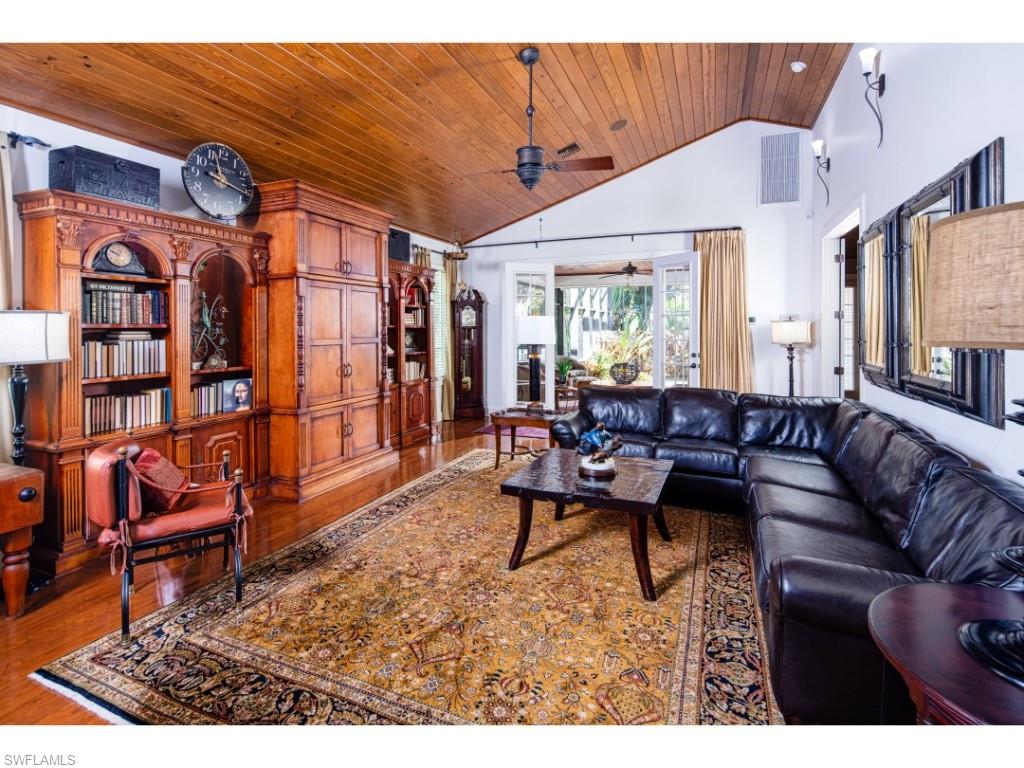 263 10th Avenue South Naples, FL 34102 - Photo 2 of 18 a living room with furniture a rug and a window