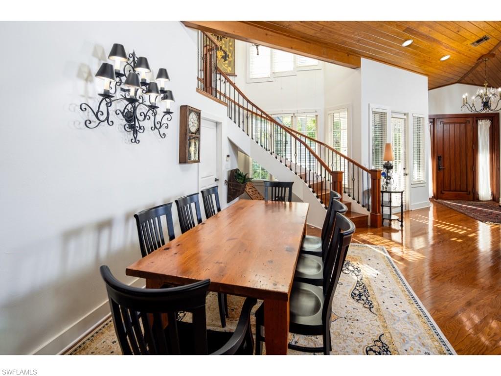 263 10th Avenue South Naples, FL 34102 - Photo 4 of 18 a view of a dining room with furniture and a chandelier