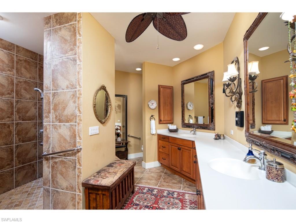 263 10th Avenue South Naples, FL 34102 - Photo 8 of 18 a large bathroom with a tub a sink and a mirror