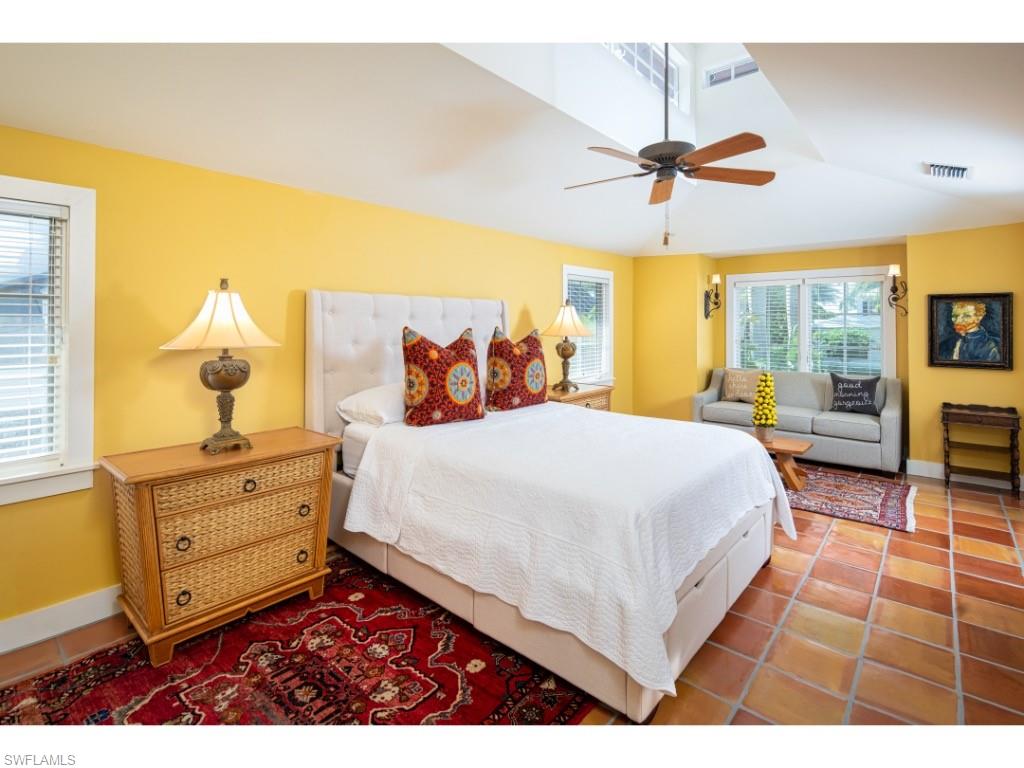 263 10th Avenue South Naples, FL 34102 - Photo 10 of 18 a bedroom with a bed and wooden floor