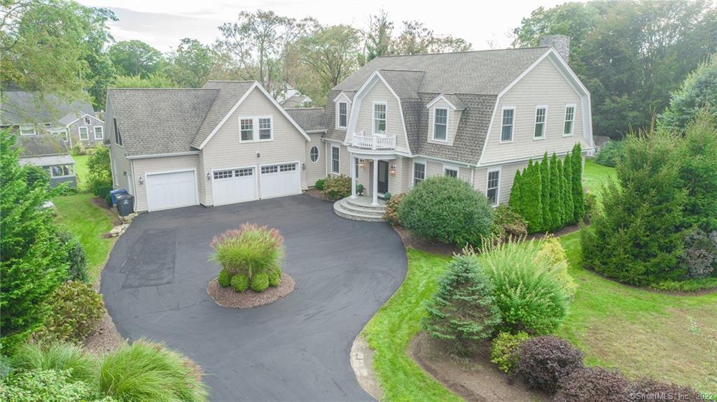 a front view of a house with a yard and a garden