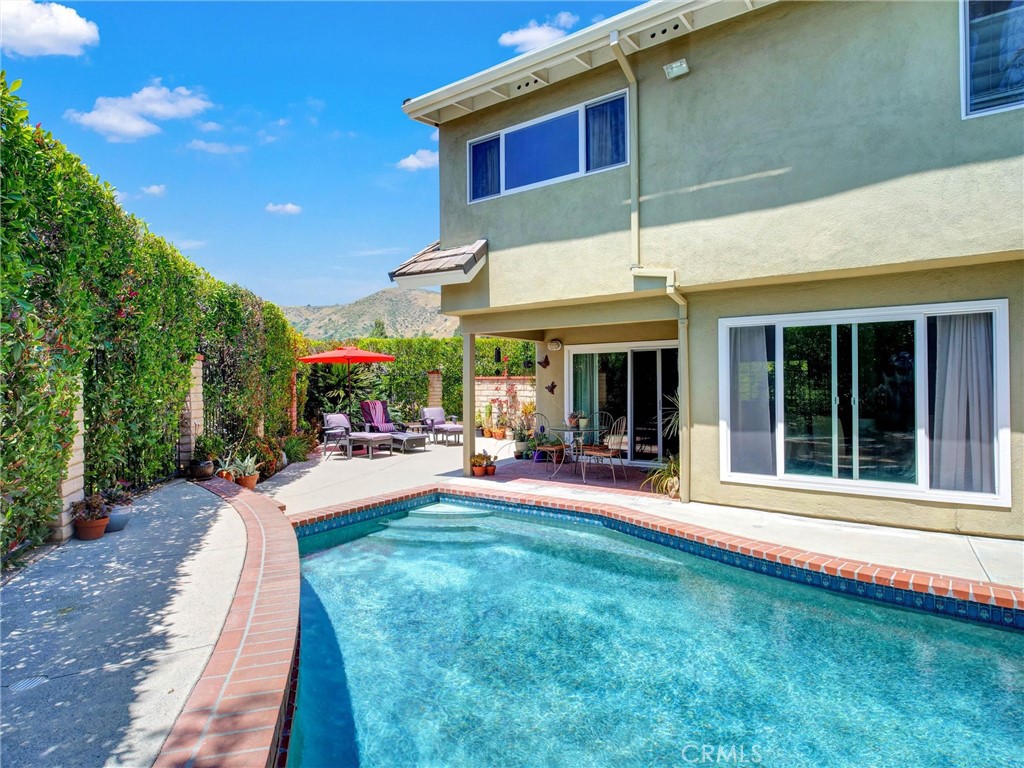 19238 Castlebay Lane Porter Ranch, CA 91326 - Photo 31 of 38 a view of a house with sitting area and garden
