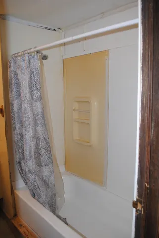 an aerial view of a house with a yard and lake view