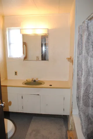 a front view of a house with a yard covered with snow in the background