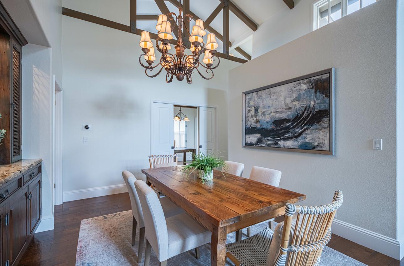25603 Creekview Circle Salinas, CA 93908 - Photo 13 of 66 a view of a dining room with furniture a chandelier and wooden floor