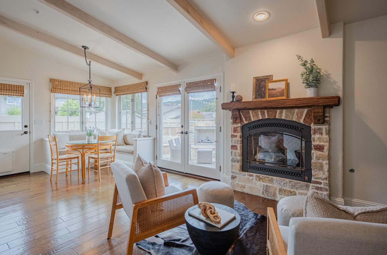 25603 Creekview Circle Salinas, CA 93908 - Photo 23 of 66 a living room with furniture a fireplace and a floor to ceiling window