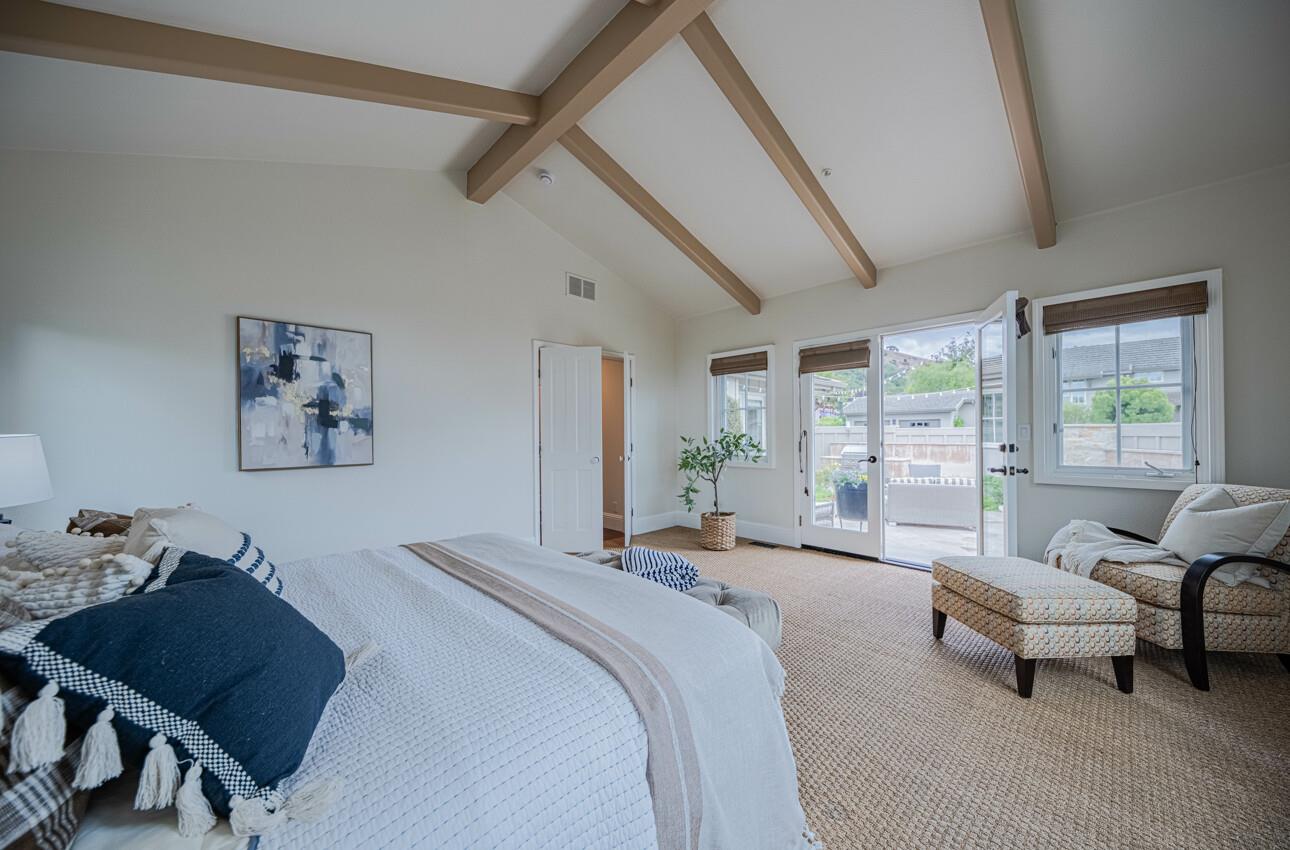 25603 Creekview Circle Salinas, CA 93908 - Photo 35 of 66 a spacious bedroom with a bed a couch and large window