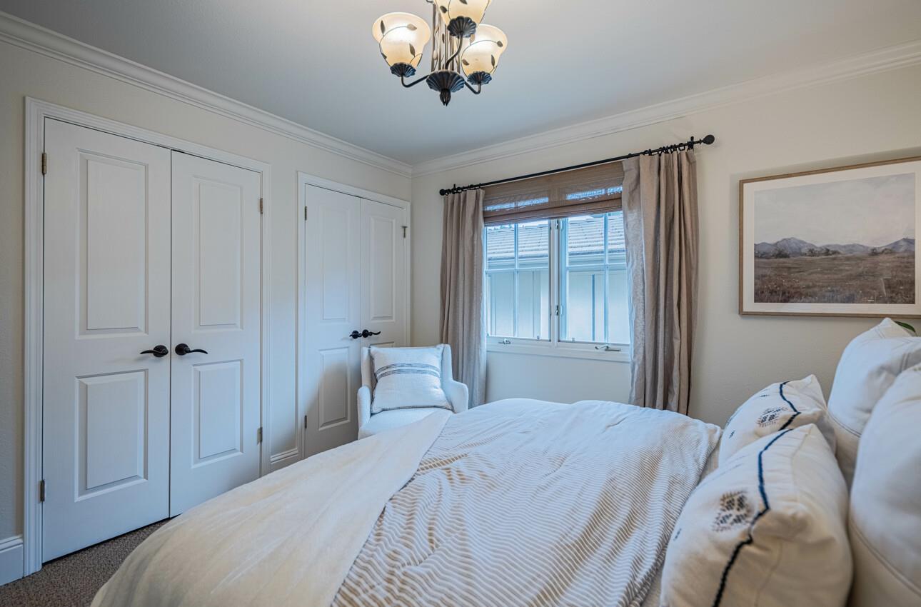 25603 Creekview Circle Salinas, CA 93908 - Photo 42 of 66 a bedroom with a bed and a chandelier