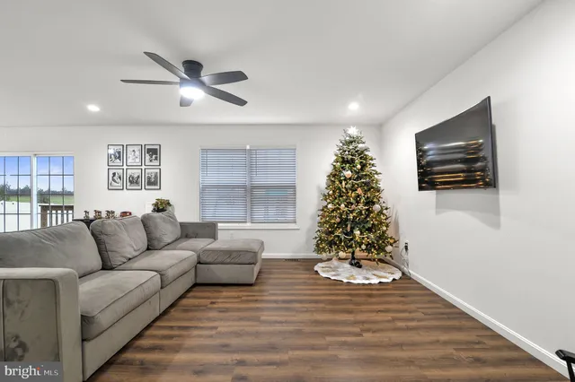 a living room with furniture and a christmas tree