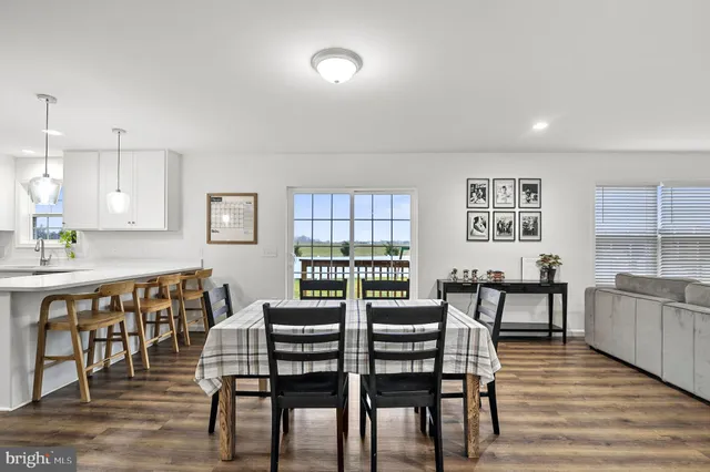 a dining room with furniture and wooden floor