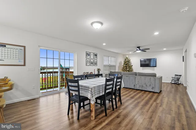 a dining room with furniture and wooden floor