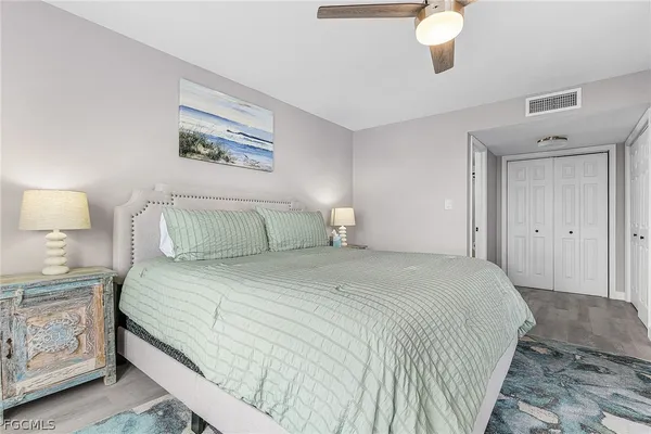 a bedroom with a bed and a lamp