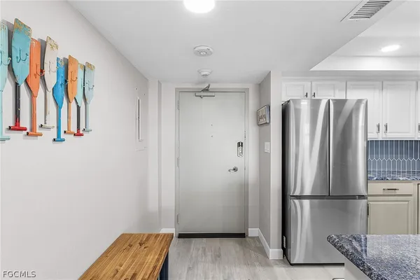 a view of kitchen with stainless steel appliances wooden floor
