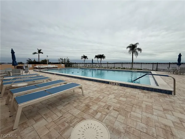 a view of swimming pool with outdoor seating