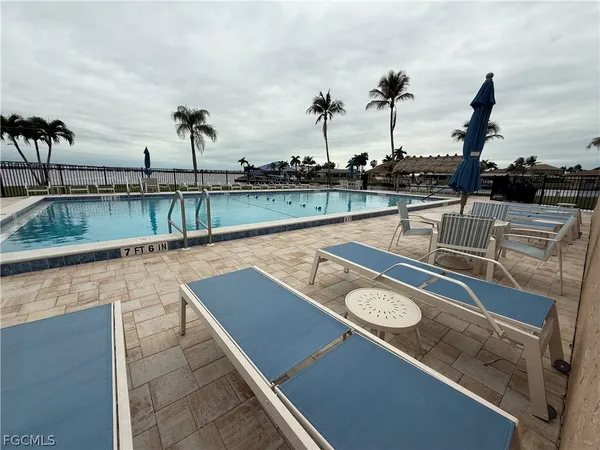 a view of a lake with a table and chairs