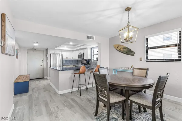 a view of a dining room with furniture and chandelier