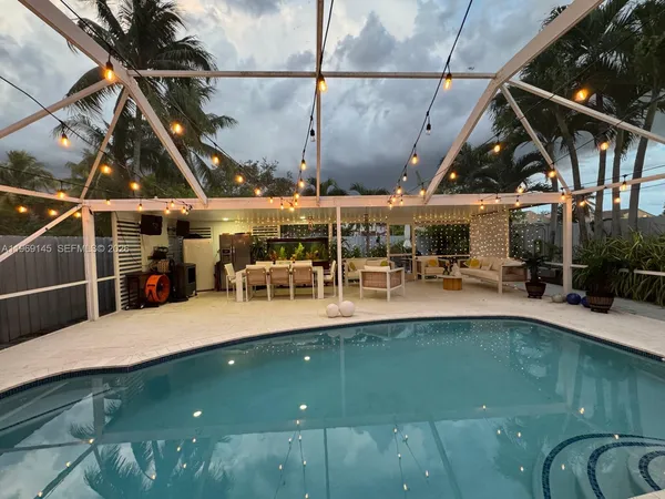 a view of a swimming pool with a patio and plants