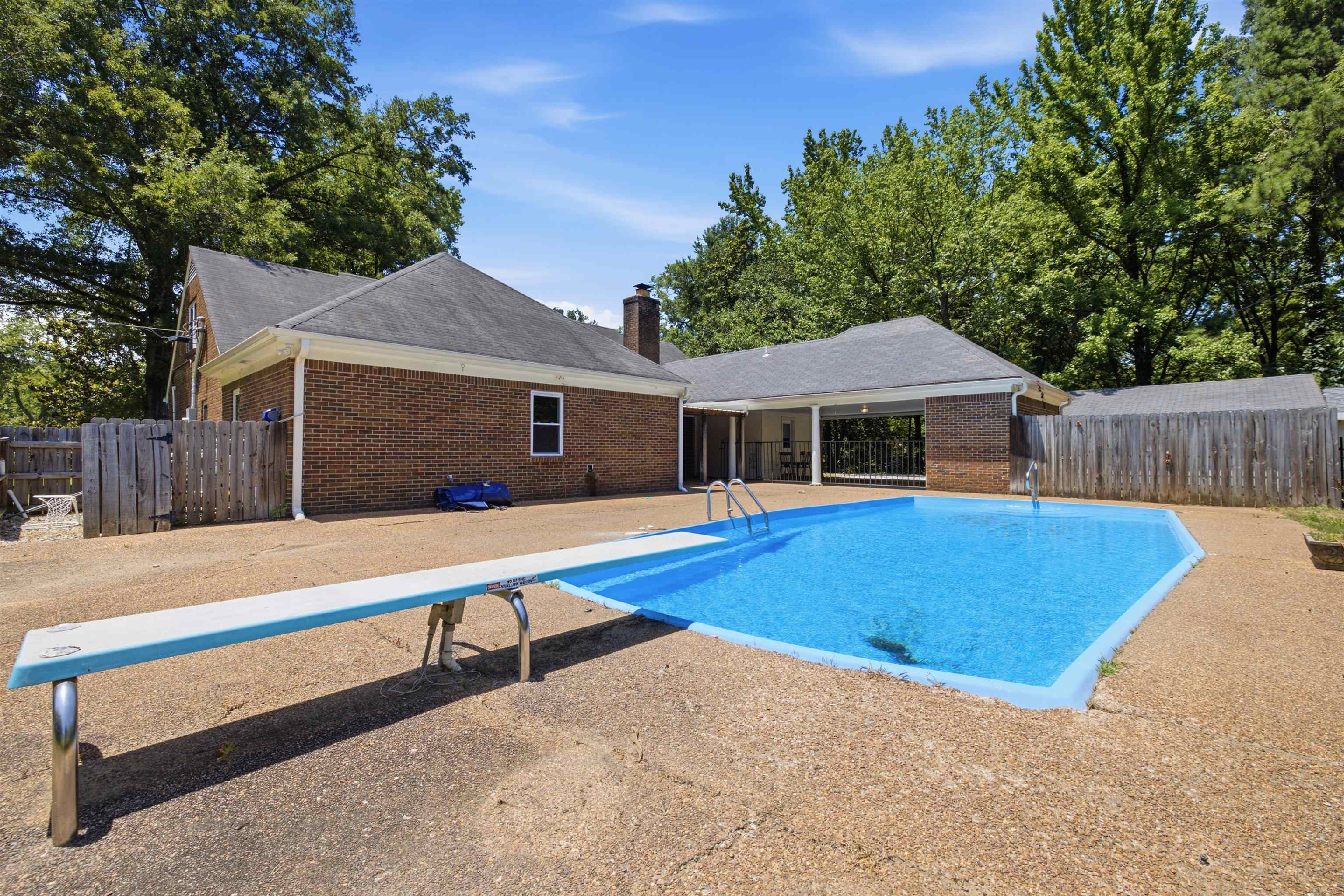 1370 North Reid Hooker Road Eads, TN 38028 - Photo 37 of 39 Expansive outdoor area featuring a swimming pool with a diving board, surrounded by aggregate concrete decking