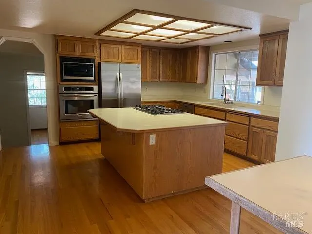 a kitchen with stainless steel appliances kitchen island a refrigerator and a stove