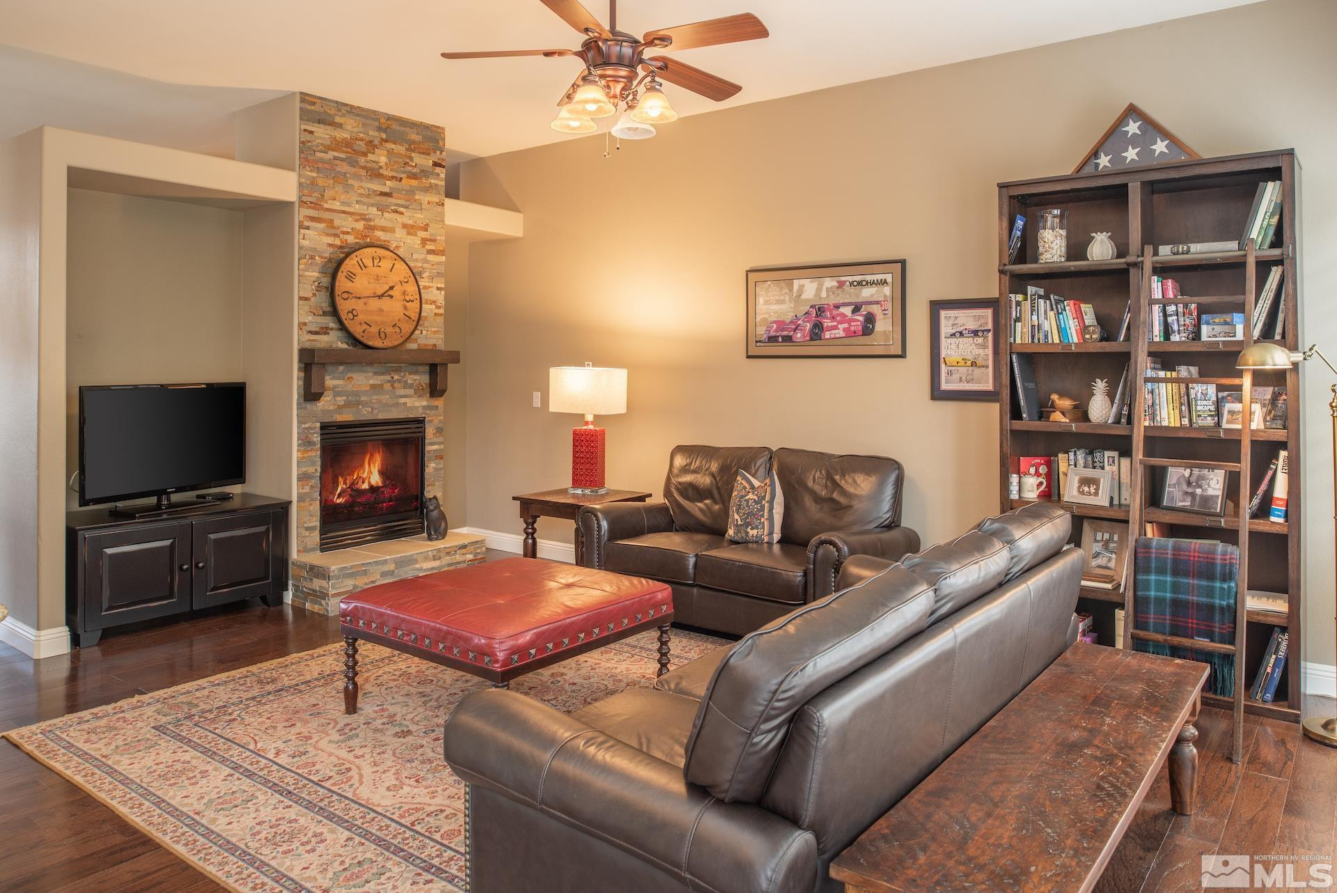 450 Flanders Road Reno, NV 89511 - Photo 9 of 36 a living room with furniture a flat screen tv and a fireplace