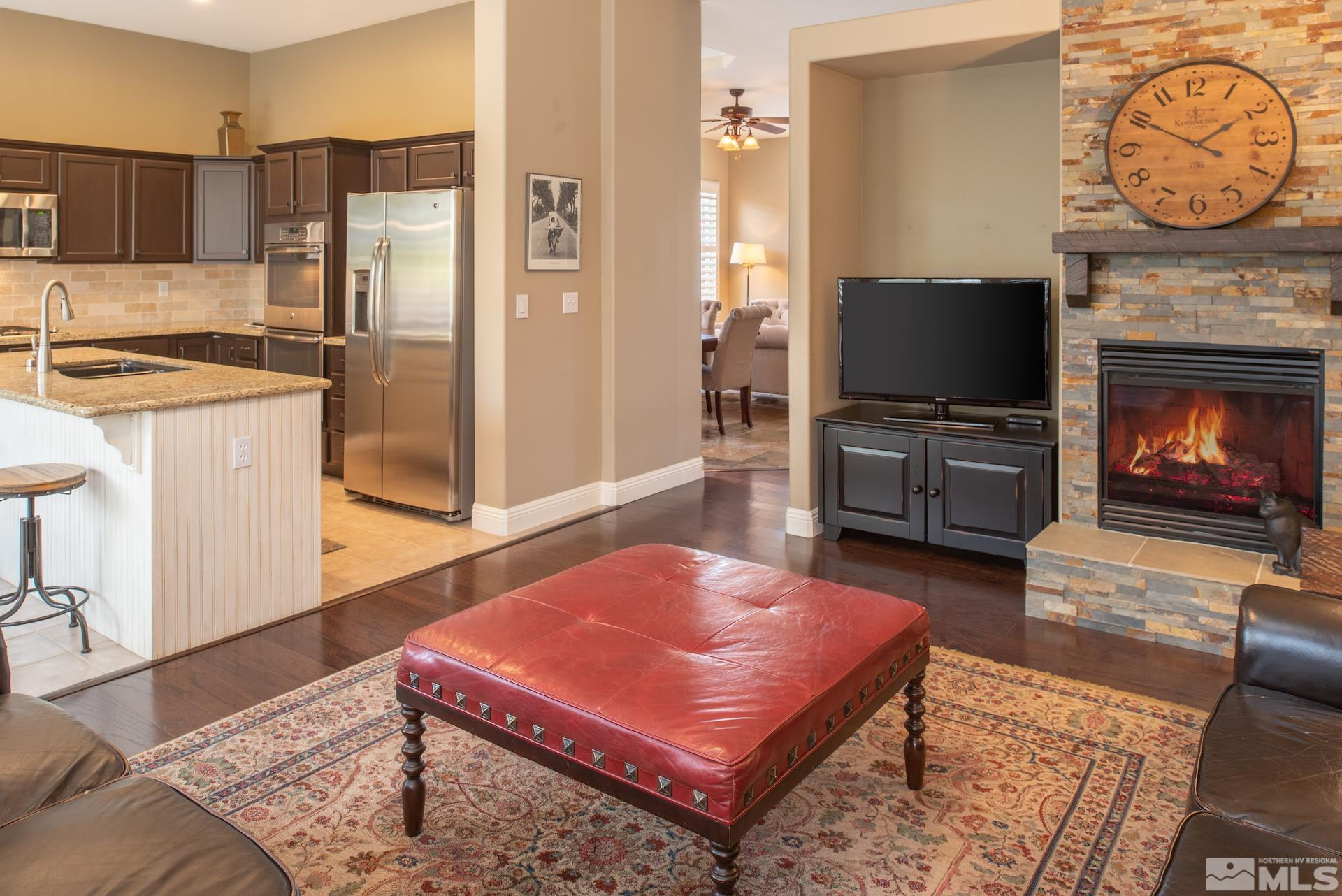 450 Flanders Road Reno, NV 89511 - Photo 10 of 36 a living room with furniture a flat screen tv and a fireplace