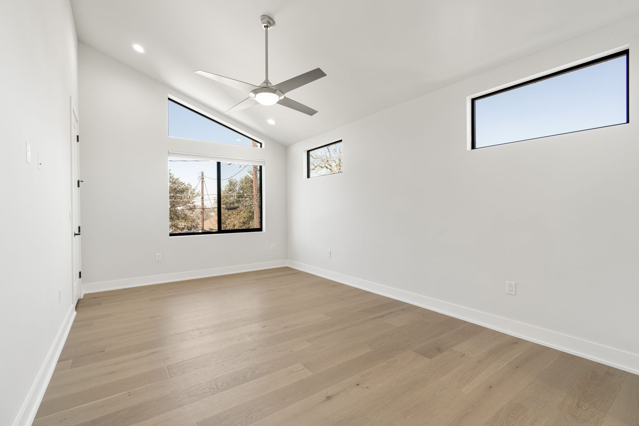 1405 Perez Street, Unit 1 Austin, TX 78721 - Photo 18 of 31 Well-proportioned bedroom with dual windows providing abundant natural light. Clean lines and recessed lighting enhance the airy feel.