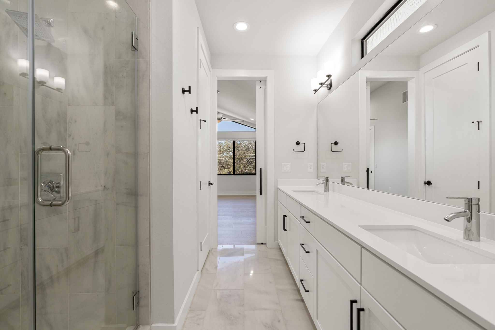 1405 Perez Street, Unit 1 Austin, TX 78721 - Photo 19 of 30 Primary bath with dual-sink vanity, quartz countertops, and sleek black hardware.