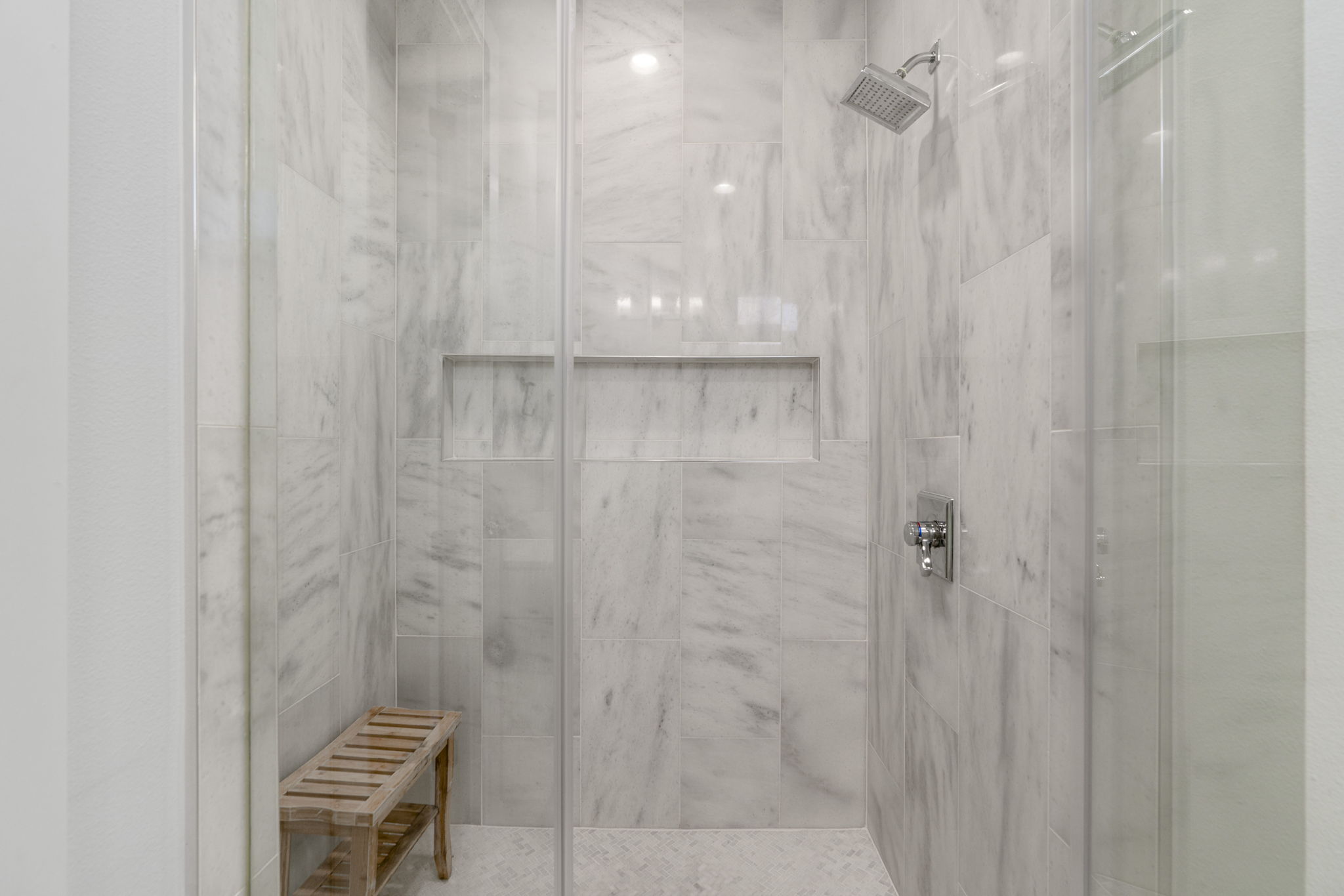 1405 Perez Street, Unit 1 Austin, TX 78721 - Photo 22 of 31 Walk-in shower with marble-look tile surround, glass enclosure, and built-in niche.